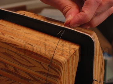 Inserting the stitch from the back side.