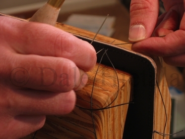 Inserting the stitch from the front side.